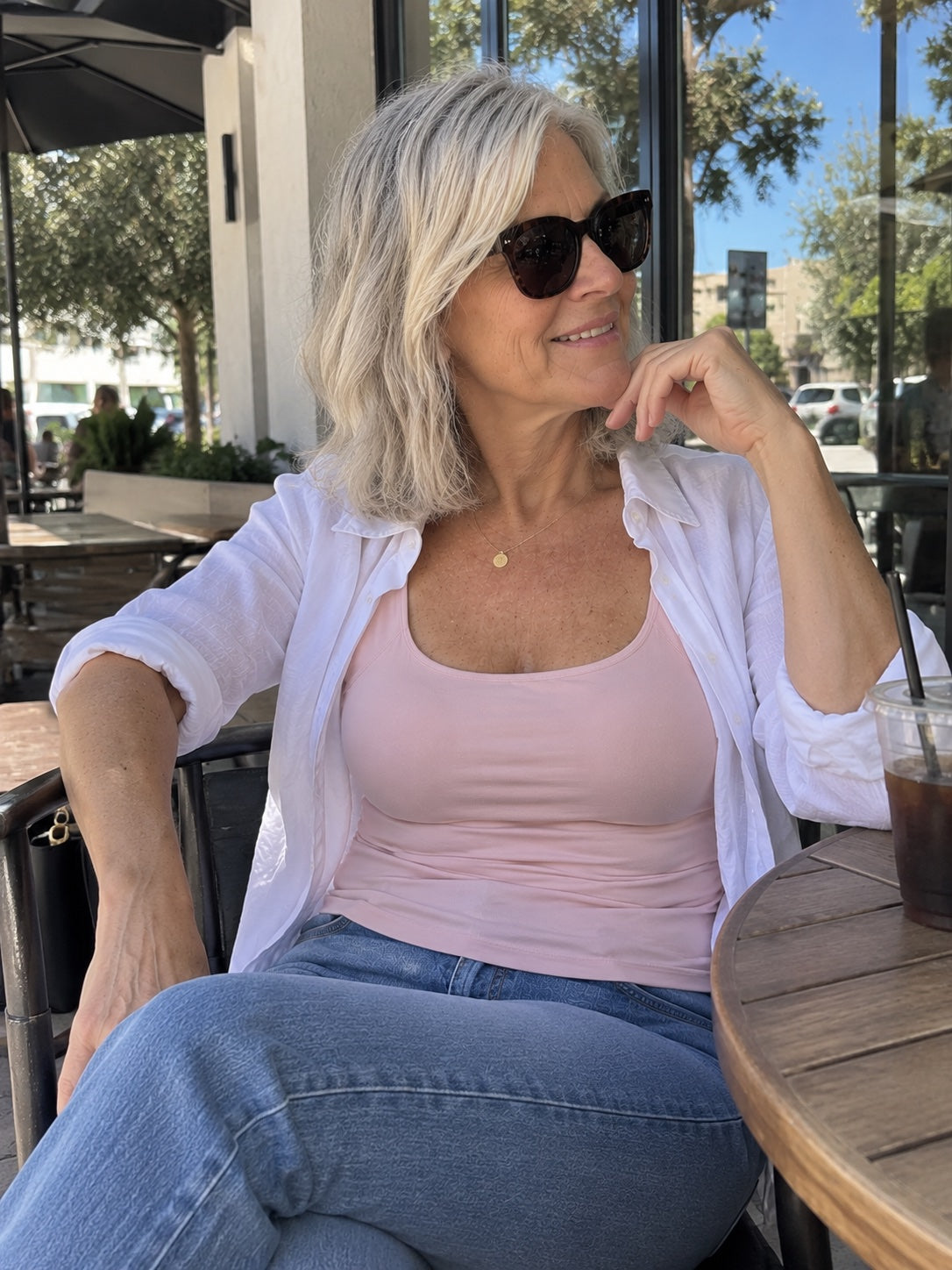 The tank worn under a pink blouse
